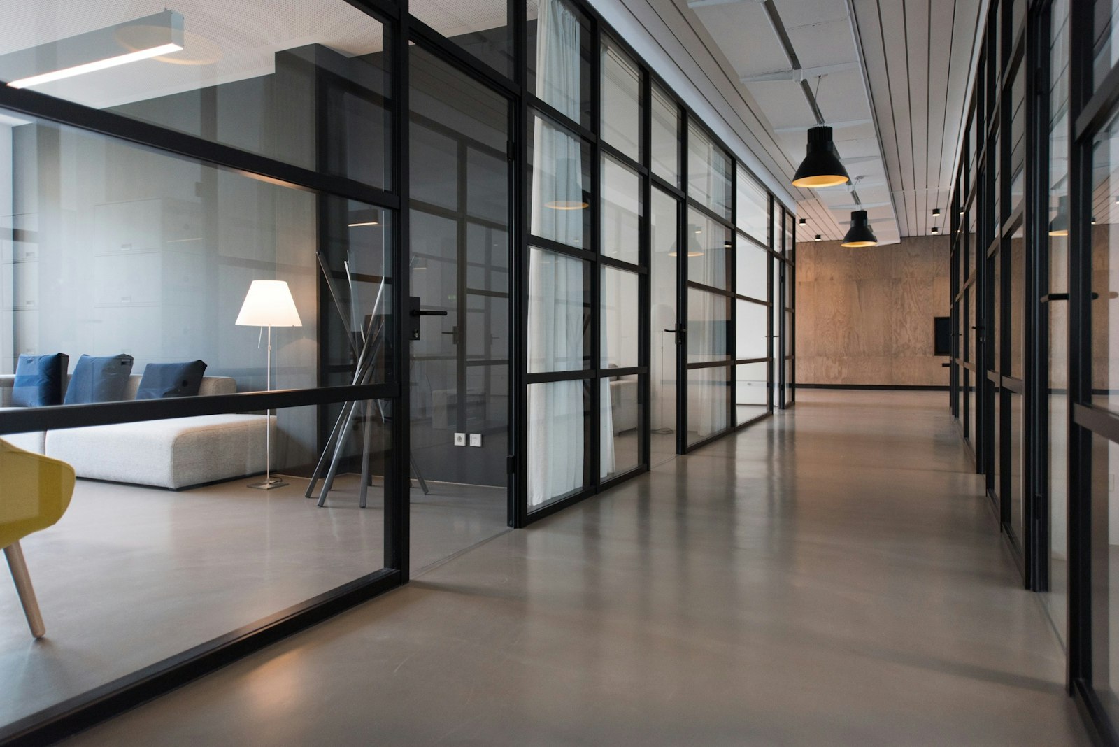 A bright workspace with a laptop showing a photo gallery and a coffee