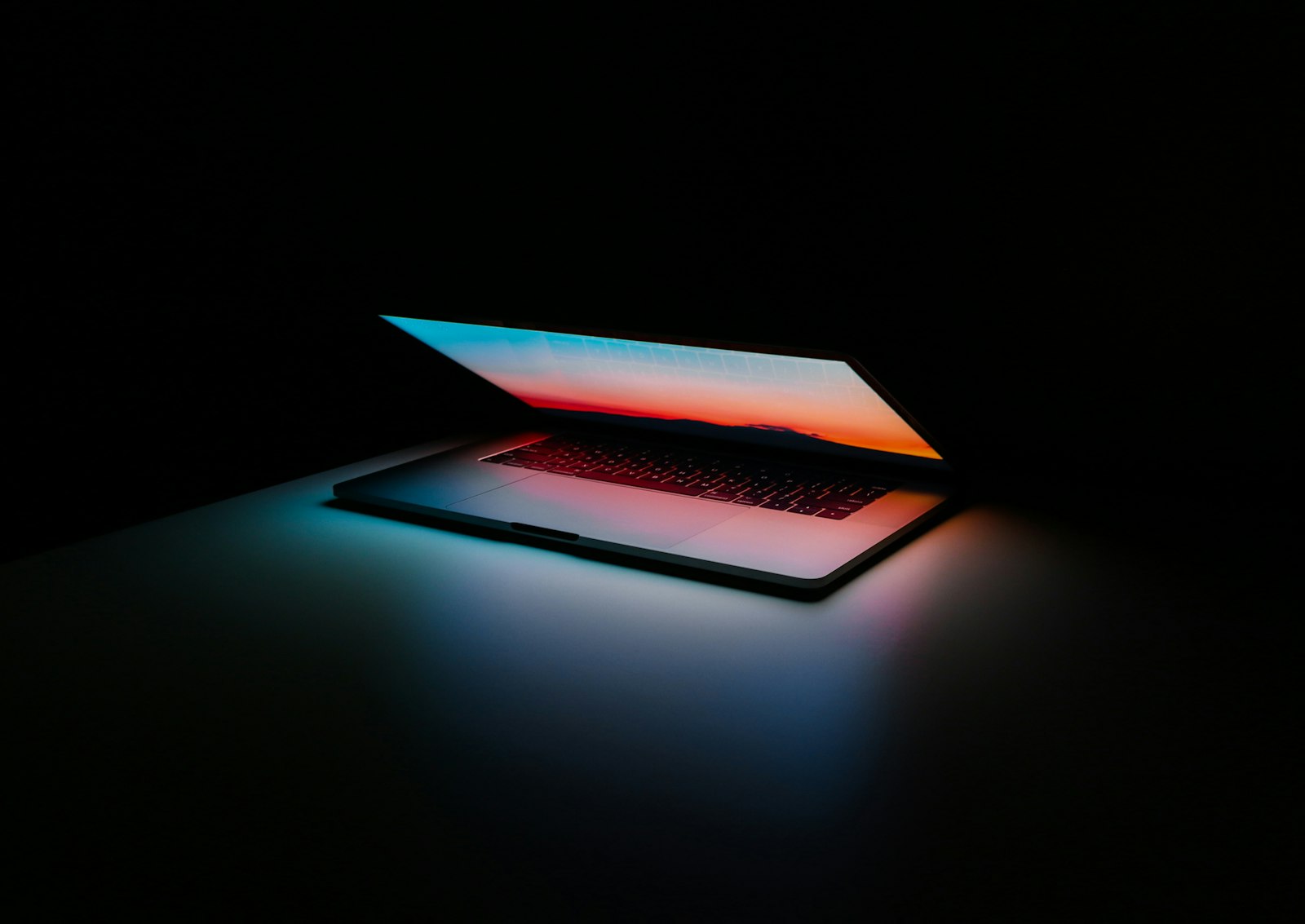 A laptop and phone side by side showing photo apps