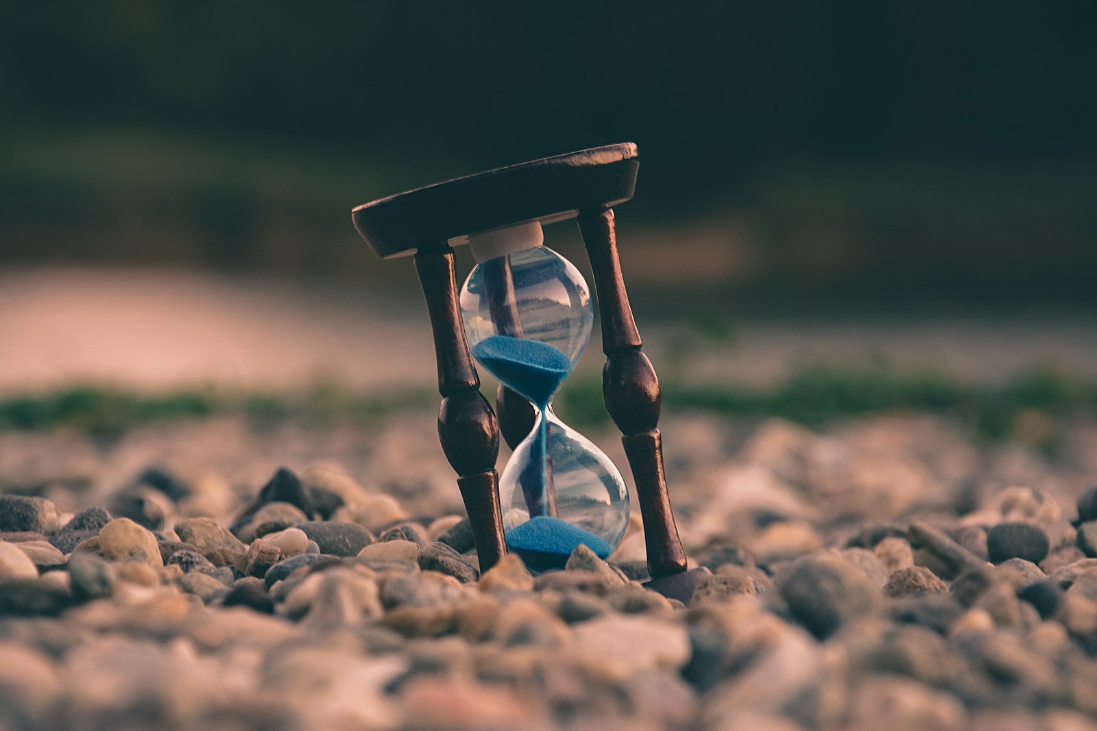 A vintage clock sitting beside a window