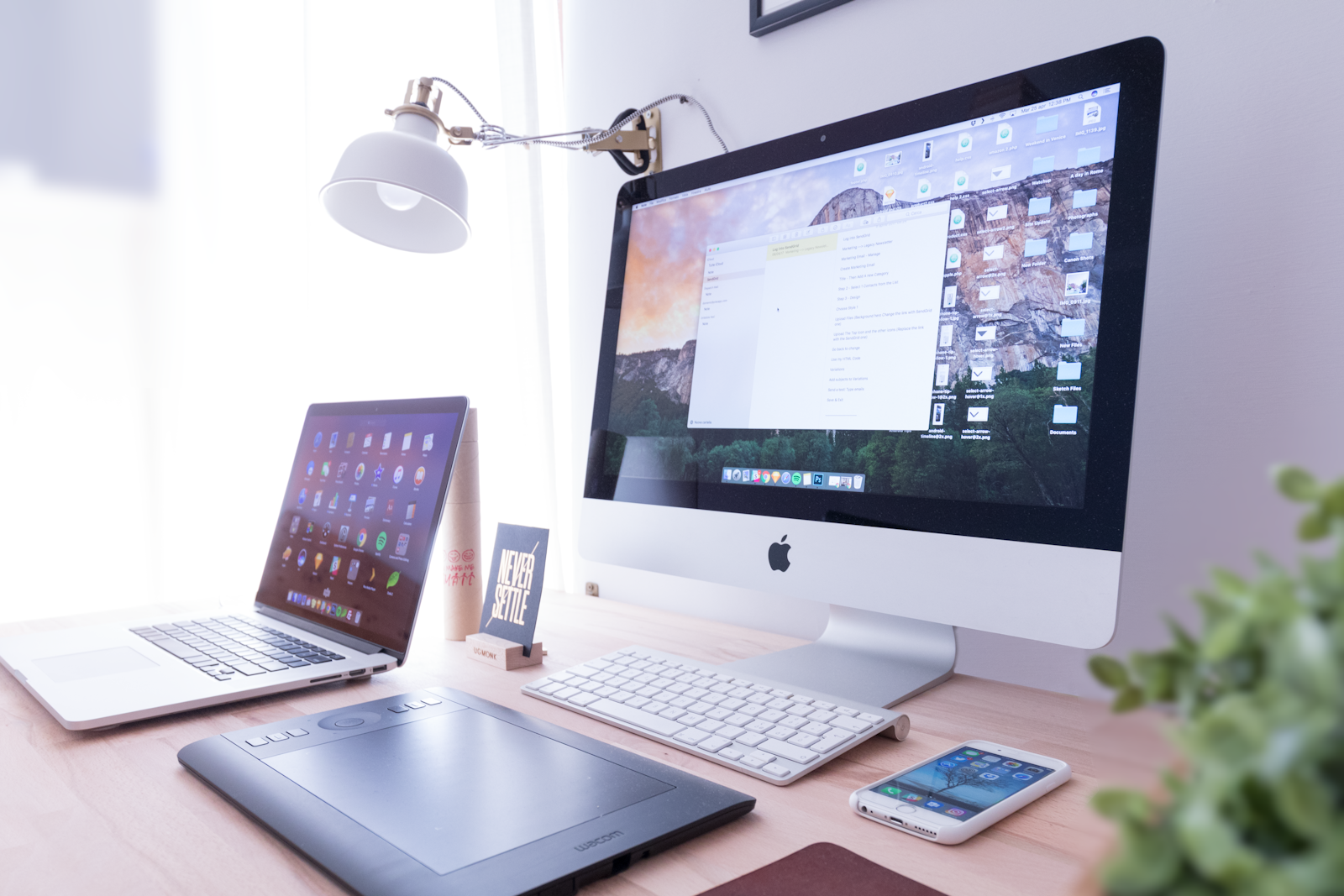 A calm workspace with a laptop showing a private gallery