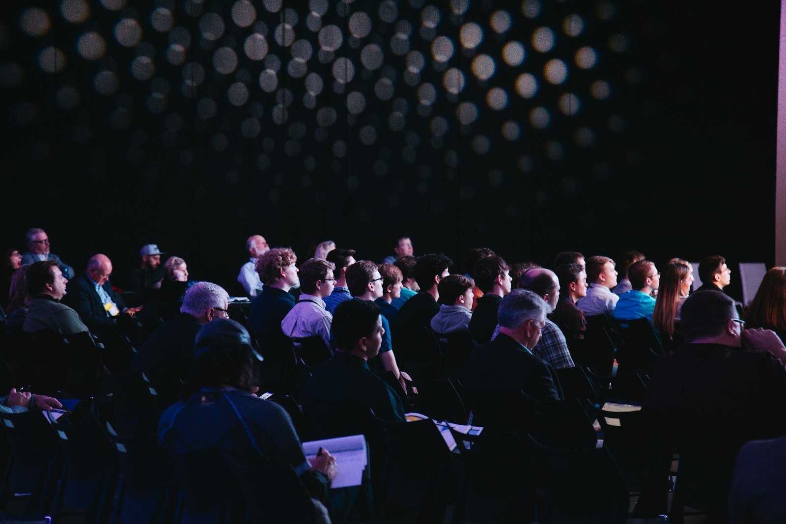 A speaker presenting to an audience at a conference