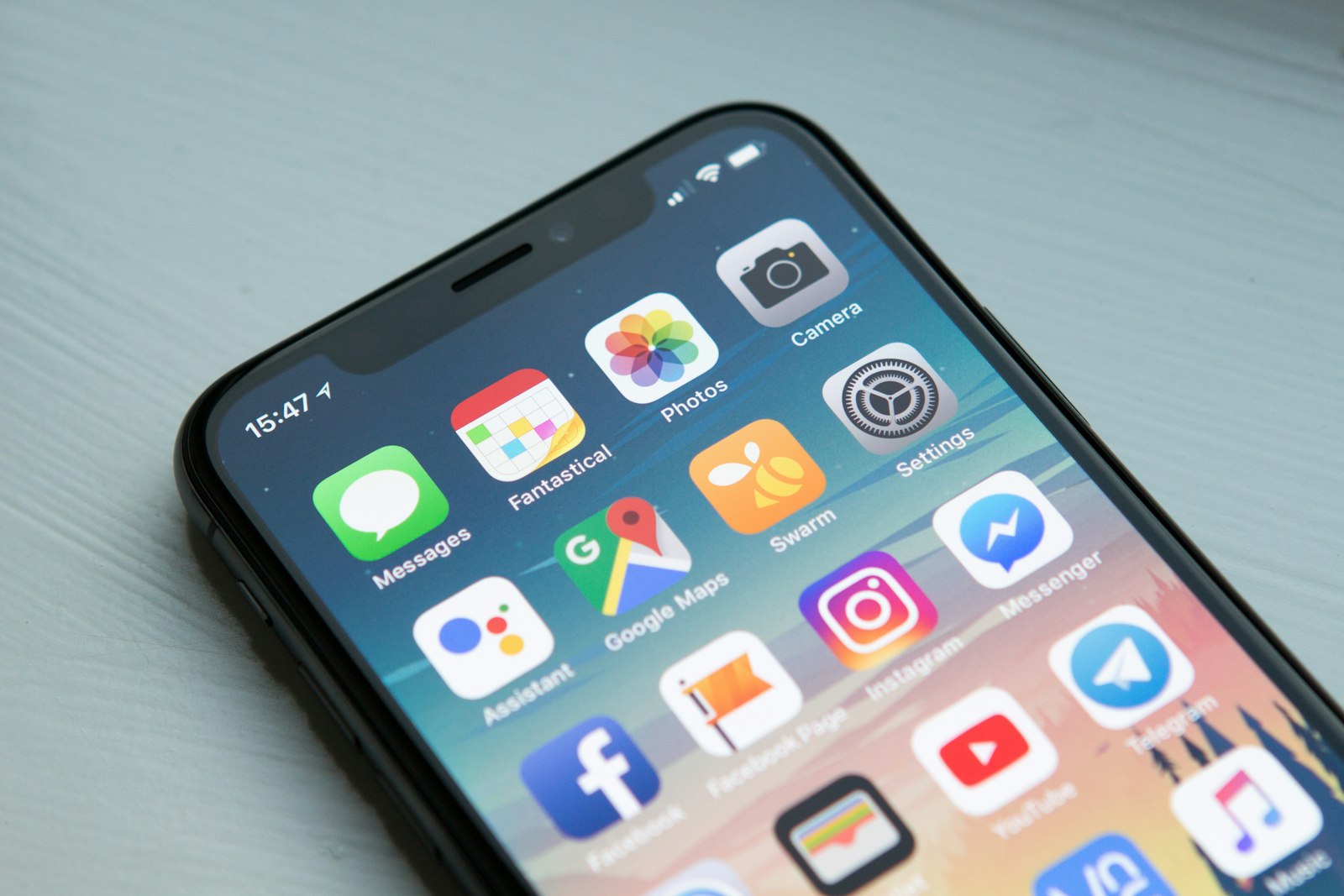 A person holding a phone showing a grid of shared holiday photos