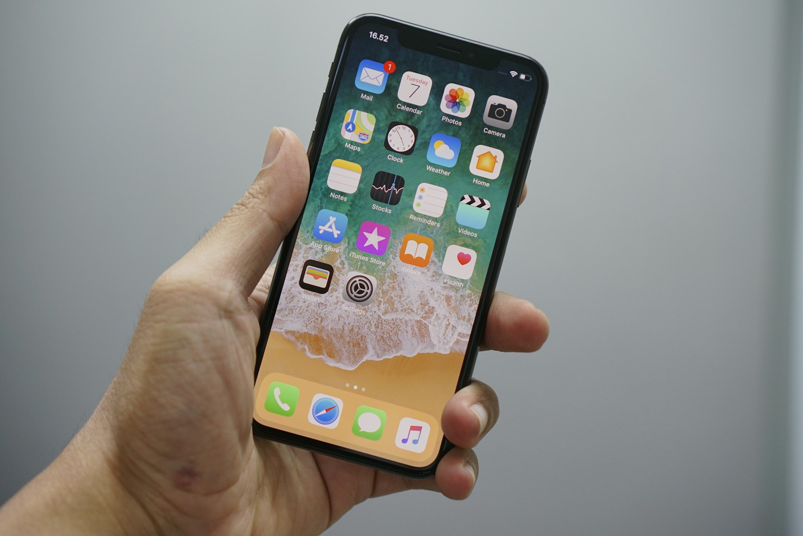 An iPhone resting on a table showing a photo gallery