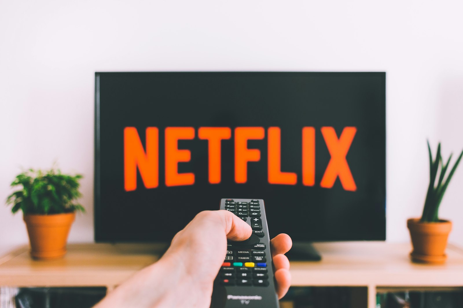 A person watching a video on a tablet on a sofa